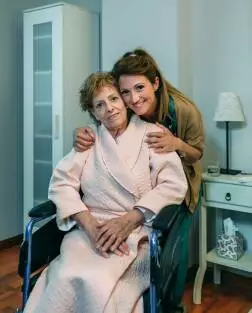 Affectionate caretaker posing with elderly patient